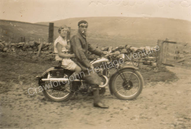 Historic photograph of Bob Allan and Jean Alexander with a motorbike